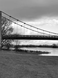 View of a bridge above water in black and white