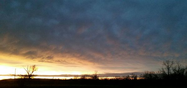 Scenic view of landscape against sky at sunset