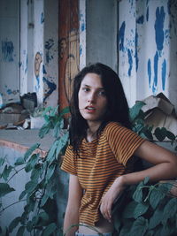 Portrait of young woman sitting outdoors