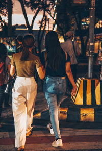 Rear view of people walking outdoors