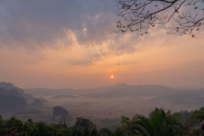 Scenic view of mountains against orange sky