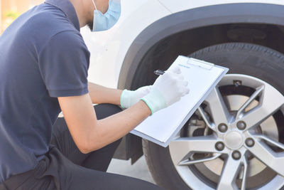 Low angle view of woman working in car