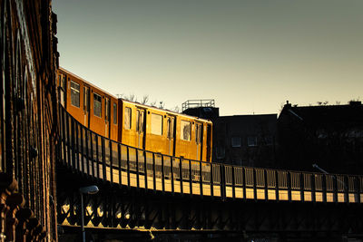 Train in city against clear sky