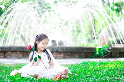 Cute girl sitting on grass