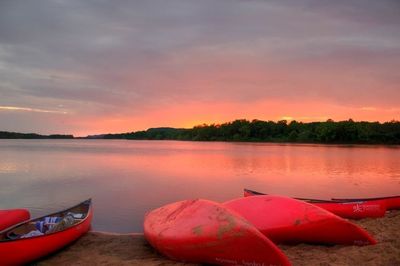 Boats in lake at sunset