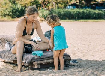 Mother playing with daughter at beach