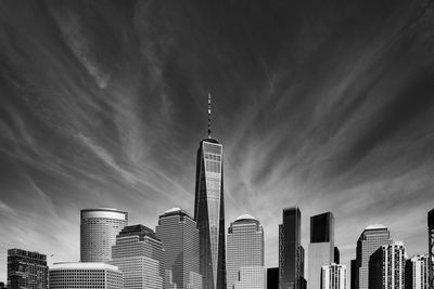 Low angle view of buildings against cloudy sky