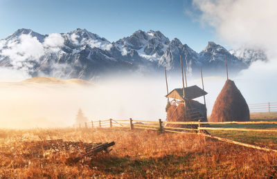 Scenic view of field against sky and mountains