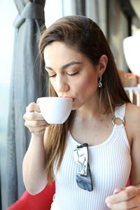 Young woman drinking coffee