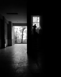 Silhouette man walking in corridor of building