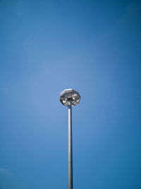 Low angle view of street light against blue sky