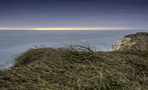 Scenic view of sea against sky at sunset