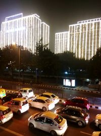 Cars on road in city at night