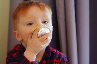 Close-up portrait of cute boy looking away