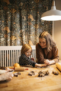 Mother and daughter making cookies