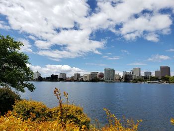 Scenic view of sea by buildings against sky