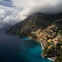 Scenic view of sea and mountains against sky