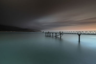 Bridge over sea against sky