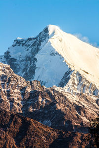 Scenic view of snow covered mountains against sky