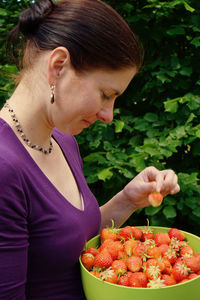 Midsection of woman holding fruits