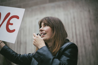 Portrait of young woman using mobile phone