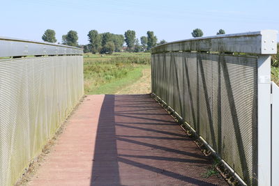 Footbridge against sky