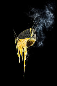 Close-up of yellow butterfly over black background