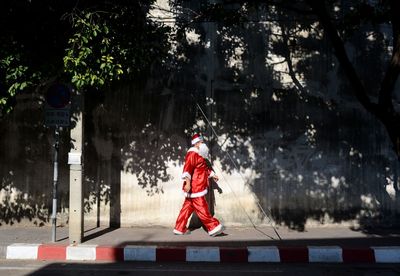 Santa claus walking on footpath