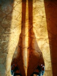 Low section of woman standing on tiled floor