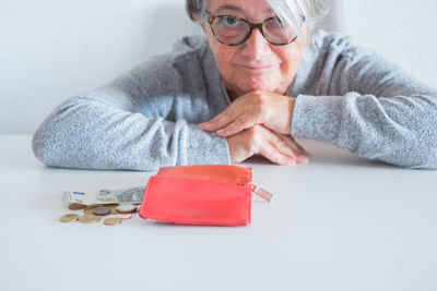 Portrait of woman wearing sunglasses on table