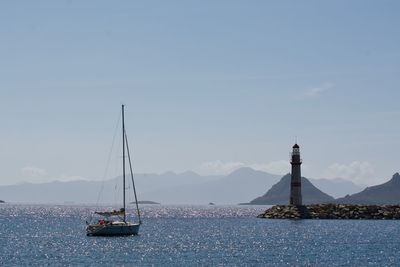 Sailboat sailing on sea against sky