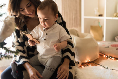 Mother and daughter sitting on floor