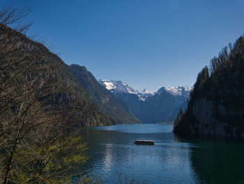 Scenic view of lake and mountains against clear sky