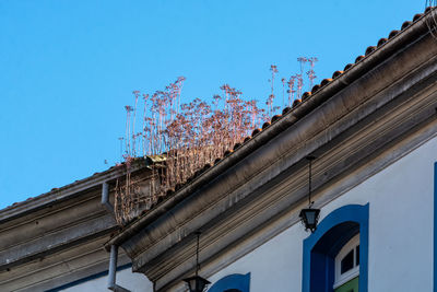 Low angle view of building against clear blue sky