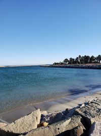 Scenic view of sea against clear blue sky