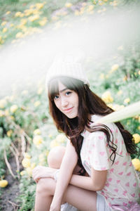 Portrait of young woman sitting outdoors