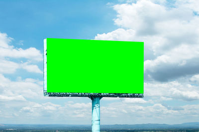 Low angle view of road sign against sky