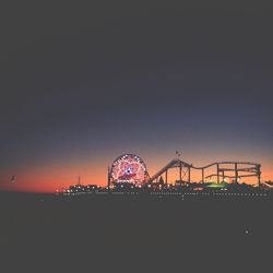 Illuminated ferris wheel at night