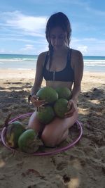 Young woman sitting on beach