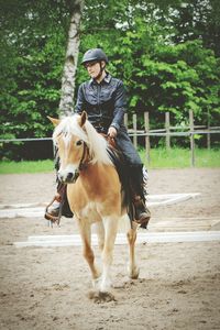 Full length of man riding horse