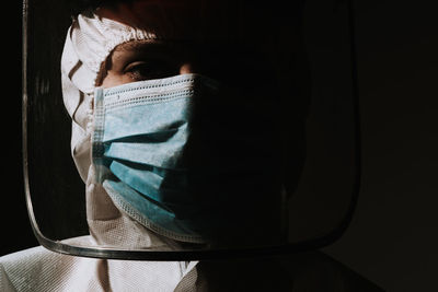 Close-up of a doctor crying tear  with mask and face shield due to coronavirus