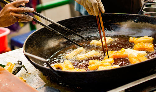 Person holding ice cream in cooking pan