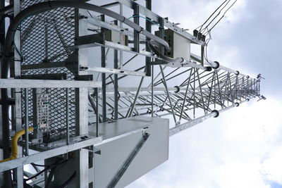 Low angle view of crane against sky