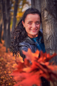 Portrait of smiling young woman in forest