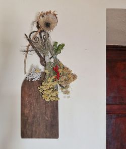 Close-up of potted plant on table against wall at home