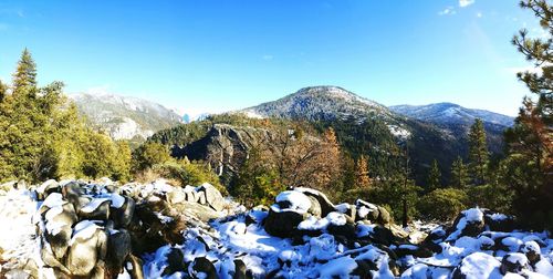 Scenic view of snowcapped mountains against blue sky
