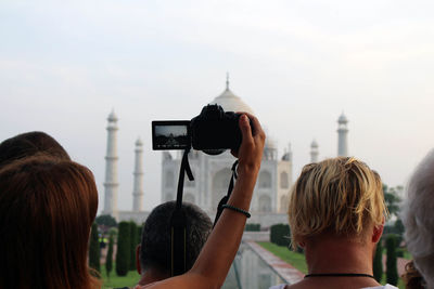 Rear view of woman photographing