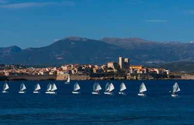 Scenic view of sea and buildings against sky