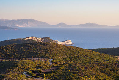 Scenic view of sea and mountains against sky