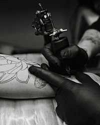 Close-up of hand tattooing